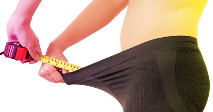 man measuring penis before enlargement